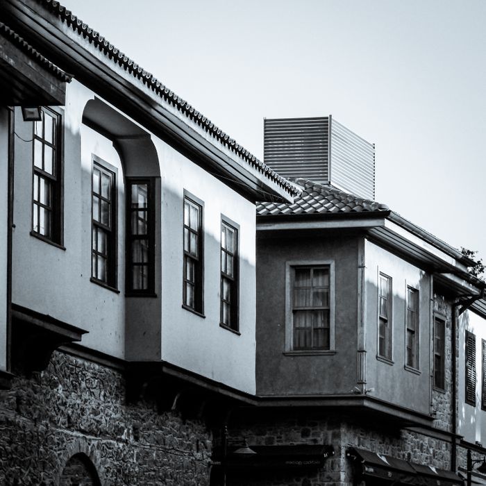 A classic architectural building façade captured in black and white showing vintage design details.